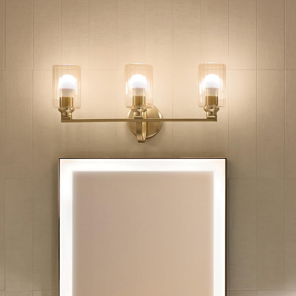 Kichler Gioe 24.25' 3-Light Bathroom Vanity Light Fixture with Clear Fluted Glass in Champagne Bronze, Damp Rated for Mirror, Powder Room (24.25' W x 10.5' H), 55226CPZFLU