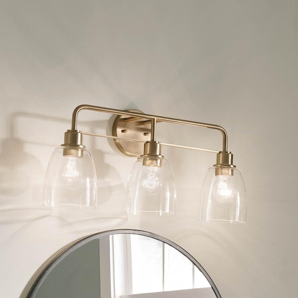 Kichler Meller 24.25' 3-Light Bathroom Vanity Light Fixture with Clear Glass Shades in Champagne Bronze for Mirror or Powder Room (24.25' W x 11.25' H x 7' D) 55102CPZ