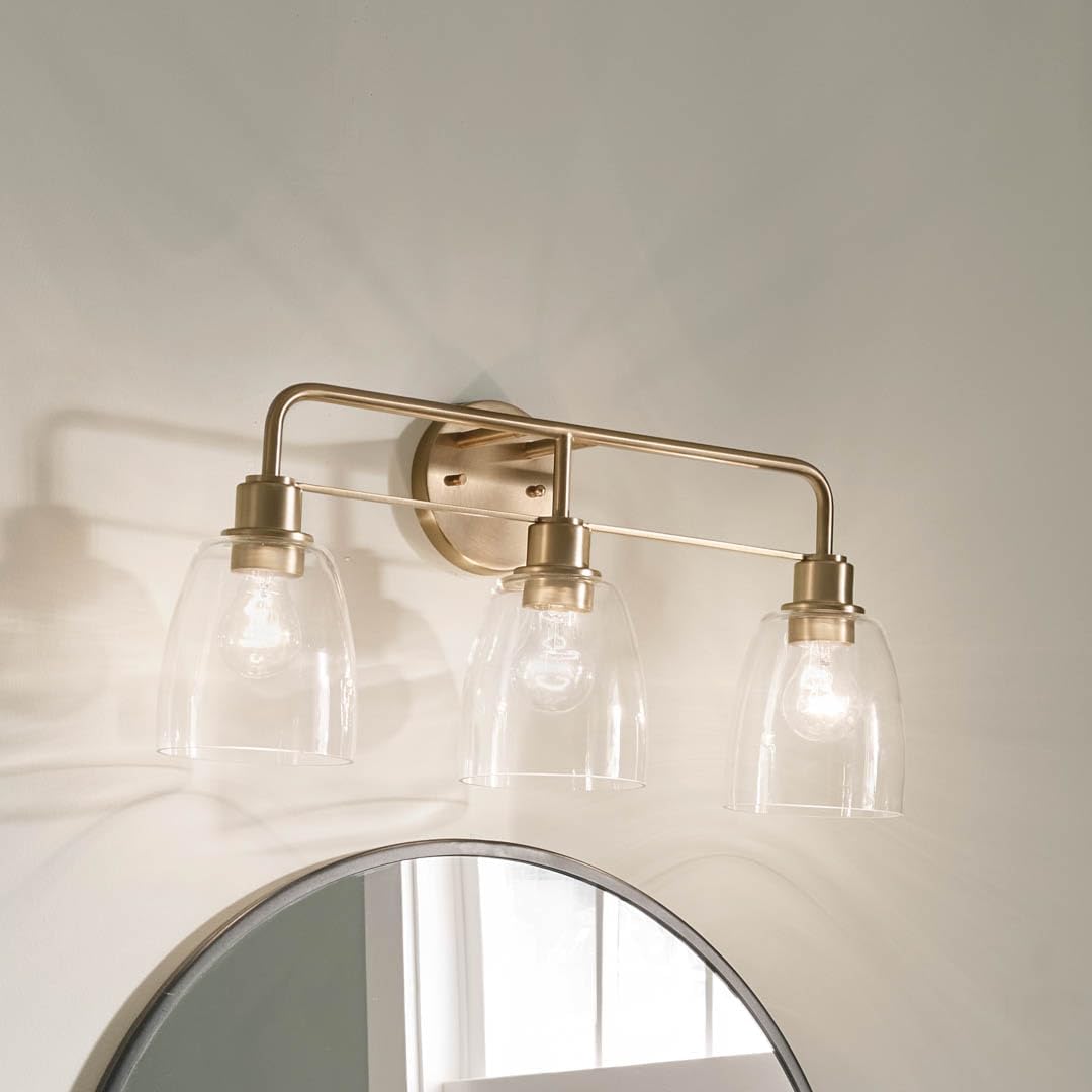 Kichler Meller 24.25' 3-Light Bathroom Vanity Light Fixture with Clear Glass Shades in Champagne Bronze for Mirror or Powder Room (24.25' W x 11.25' H x 7' D) 55102CPZ