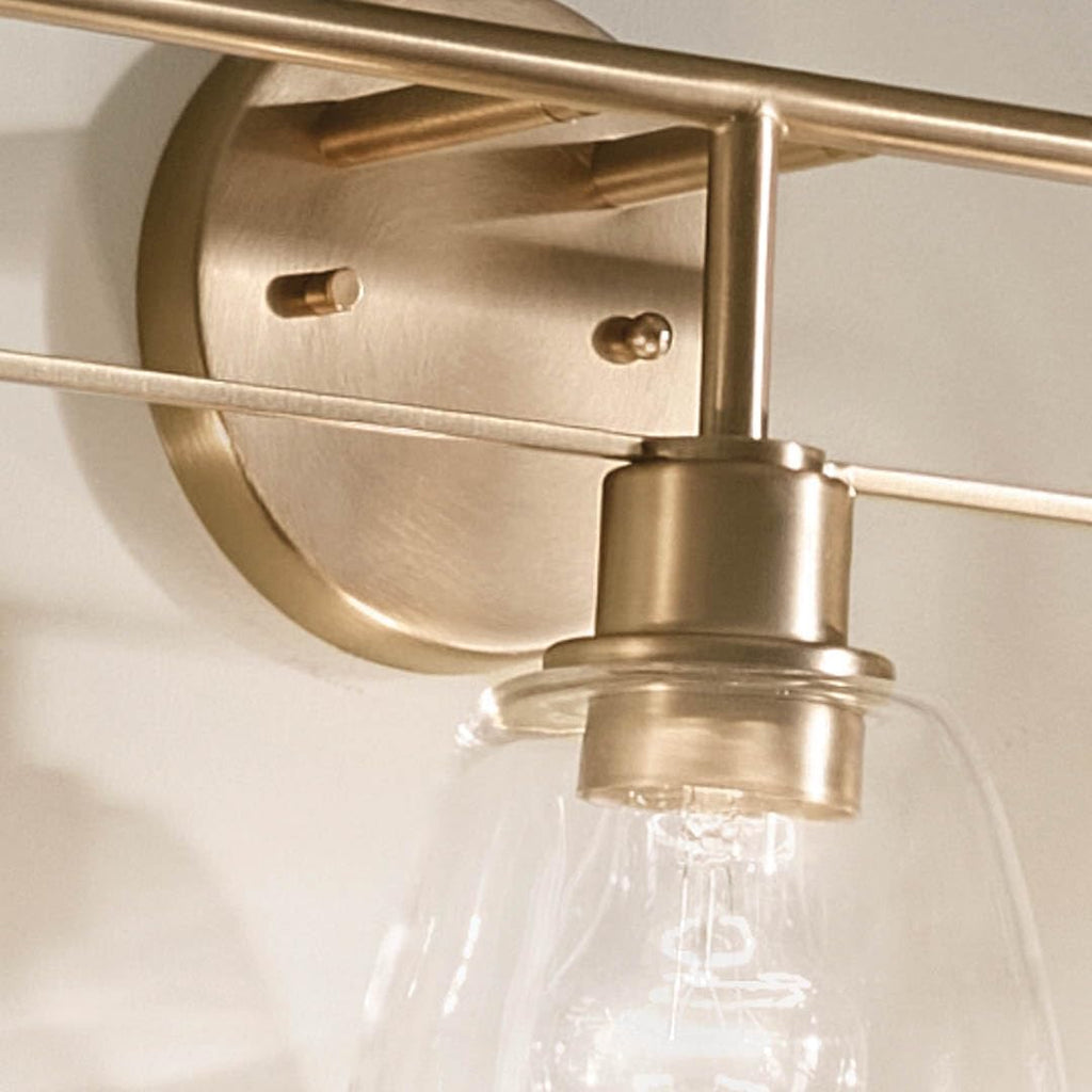 Kichler Meller 24.25' 3-Light Bathroom Vanity Light Fixture with Clear Glass Shades in Champagne Bronze for Mirror or Powder Room (24.25' W x 11.25' H x 7' D) 55102CPZ