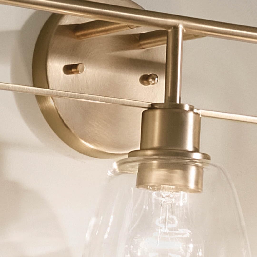 Kichler Meller 24.25' 3-Light Bathroom Vanity Light Fixture with Clear Glass Shades in Champagne Bronze for Mirror or Powder Room (24.25' W x 11.25' H x 7' D) 55102CPZ