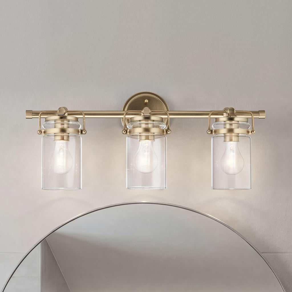 Kichler Brinley 24' 3-Light Bathroom Vanity Light Fixture with Clear Glass in Champagne Bronze, Modern Farmhouse Mason Jar Style for Mirror Lighting (24' W x 10.25' H), 45689CPZ