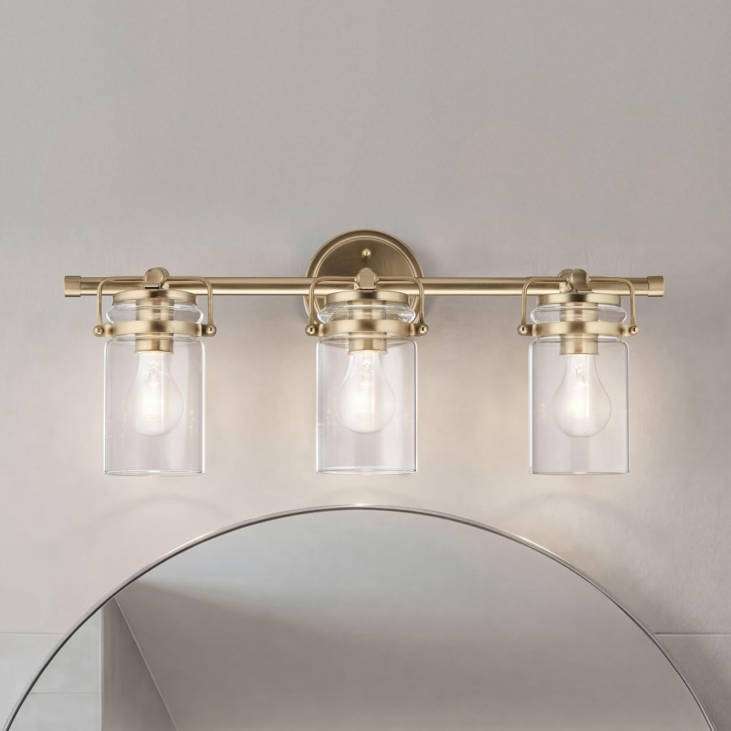 Kichler Brinley 24' 3-Light Bathroom Vanity Light Fixture with Clear Glass in Champagne Bronze, Modern Farmhouse Mason Jar Style for Mirror Lighting (24' W x 10.25' H), 45689CPZ