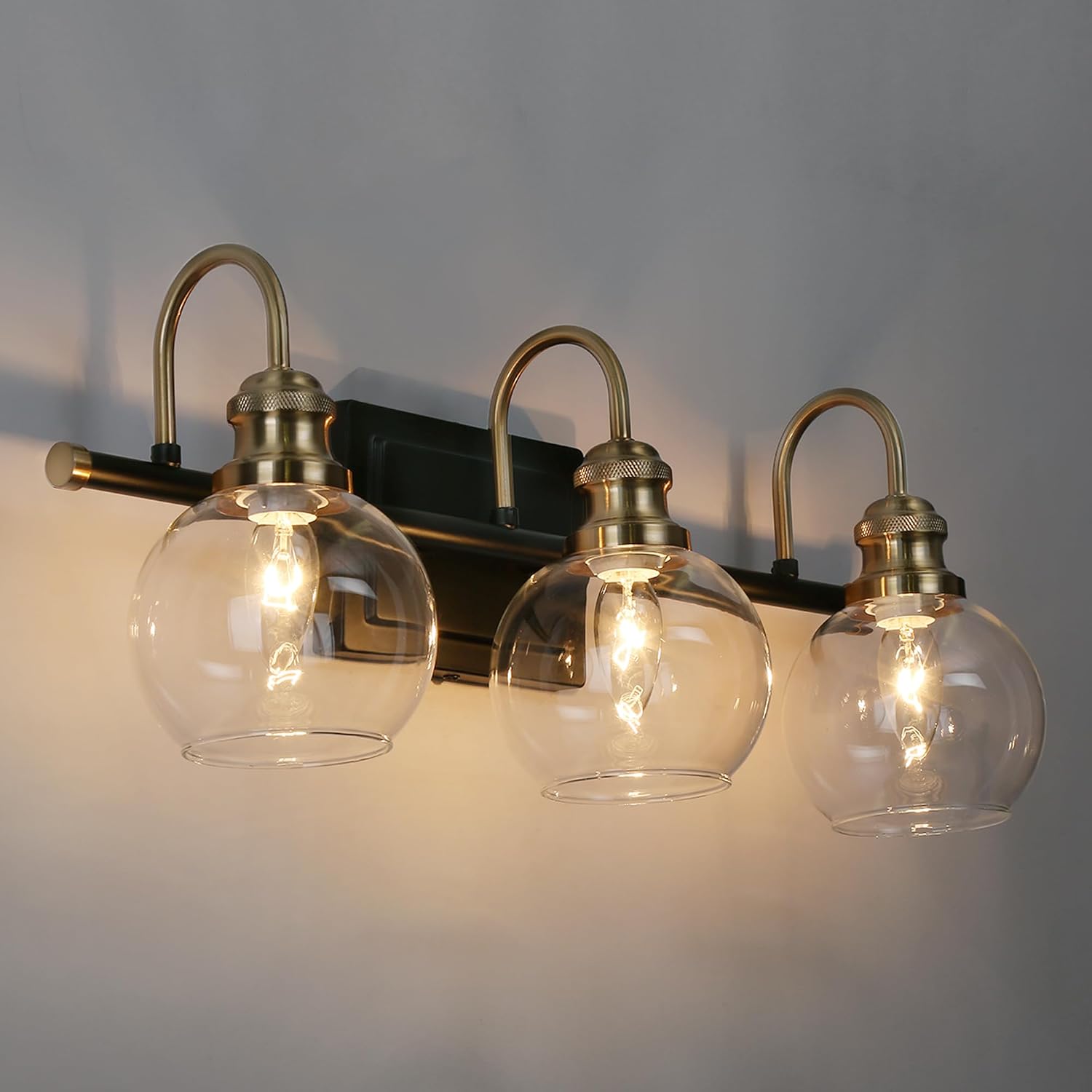 KSANA Black Gold Vanity Light, Modern 3-Light Bathroom Light Fixture with Clear Glass Globes, Electroplating Brass 22'L Vanity Lighting Over Mirror