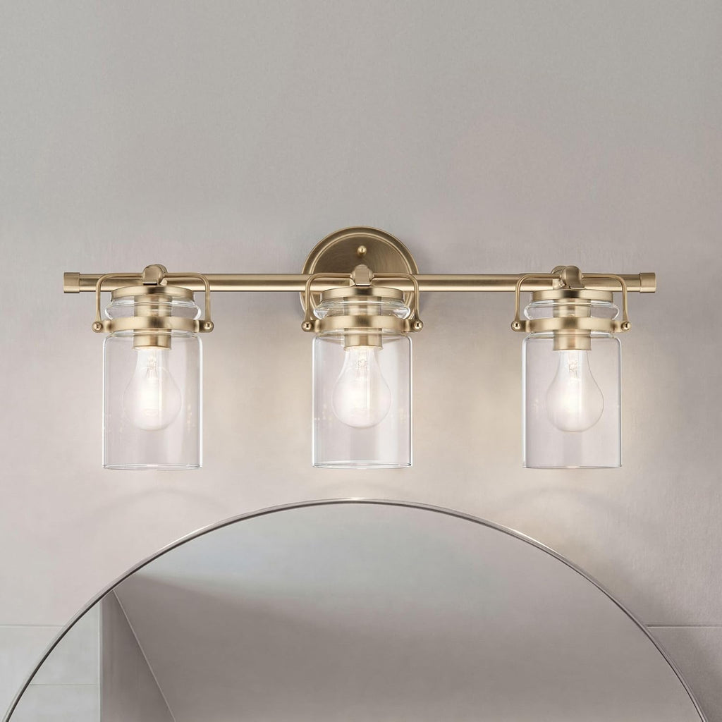 Kichler Brinley 24' 3-Light Bathroom Vanity Light Fixture with Clear Glass in Champagne Bronze, Modern Farmhouse Mason Jar Style for Mirror Lighting (24' W x 10.25' H), 45689CPZ