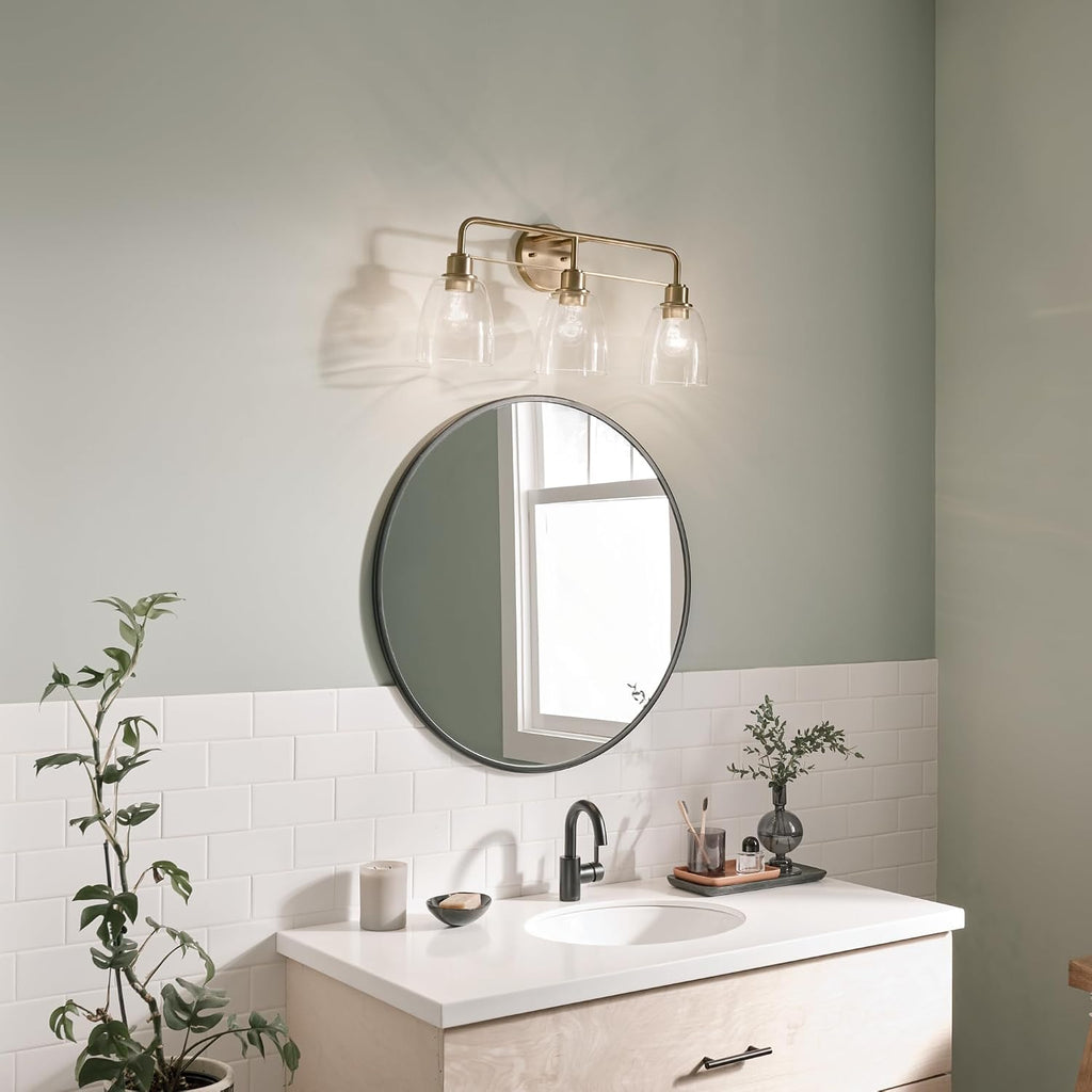 Kichler Meller 24.25' 3-Light Bathroom Vanity Light Fixture with Clear Glass Shades in Champagne Bronze for Mirror or Powder Room (24.25' W x 11.25' H x 7' D) 55102CPZ