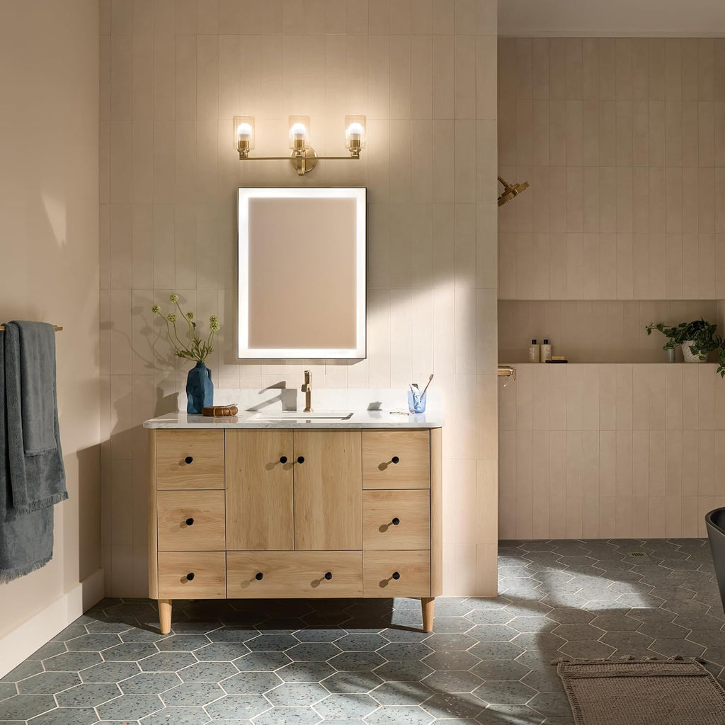 Kichler Gioe 24.25' 3-Light Bathroom Vanity Light Fixture with Clear Fluted Glass in Champagne Bronze, Damp Rated for Mirror, Powder Room (24.25' W x 10.5' H), 55226CPZFLU